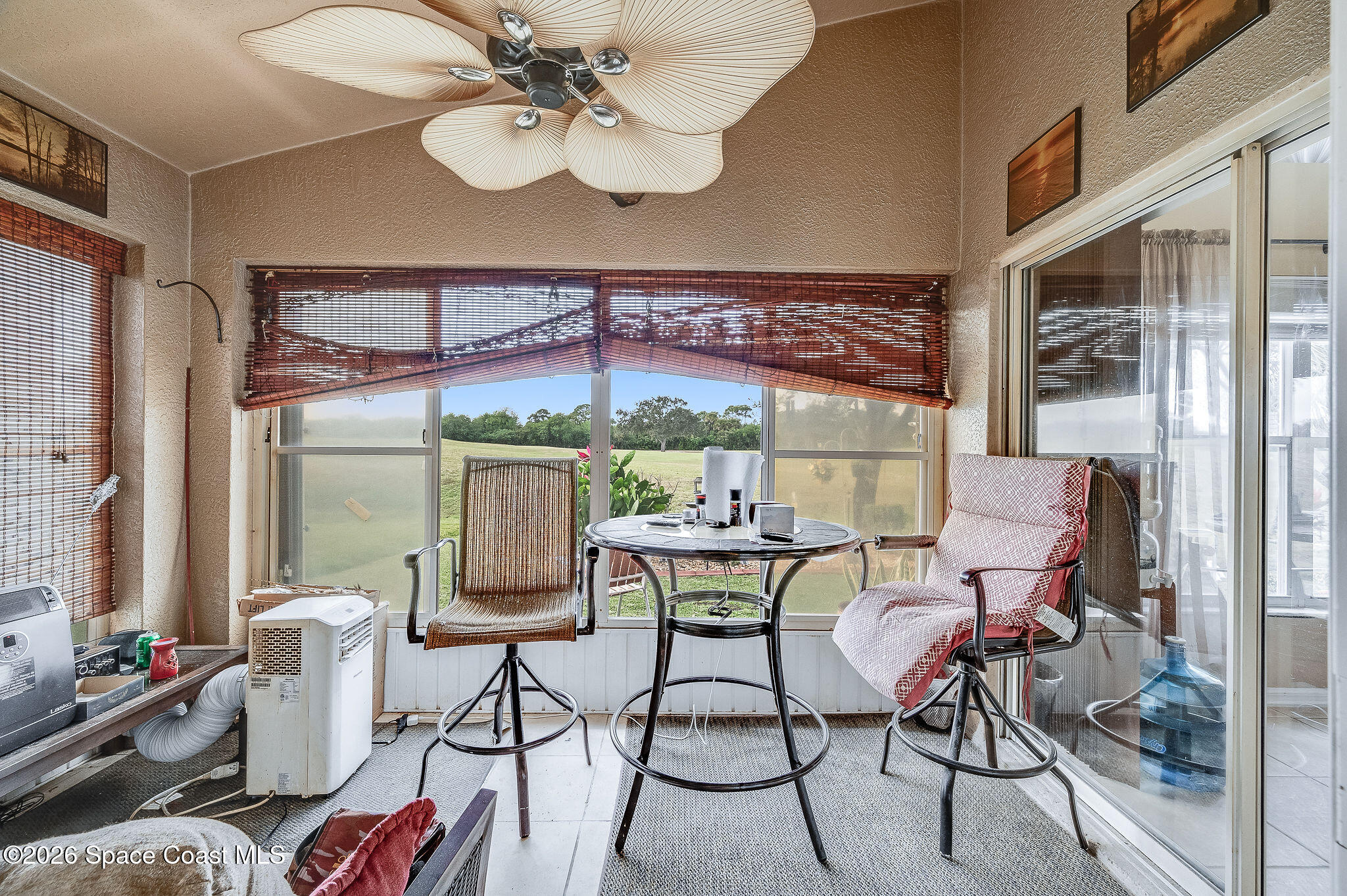 4910 Worthington Circle Rockledge, FL 32955 - Photo 41 of 69 a dining room with furniture a large window and a chandelier