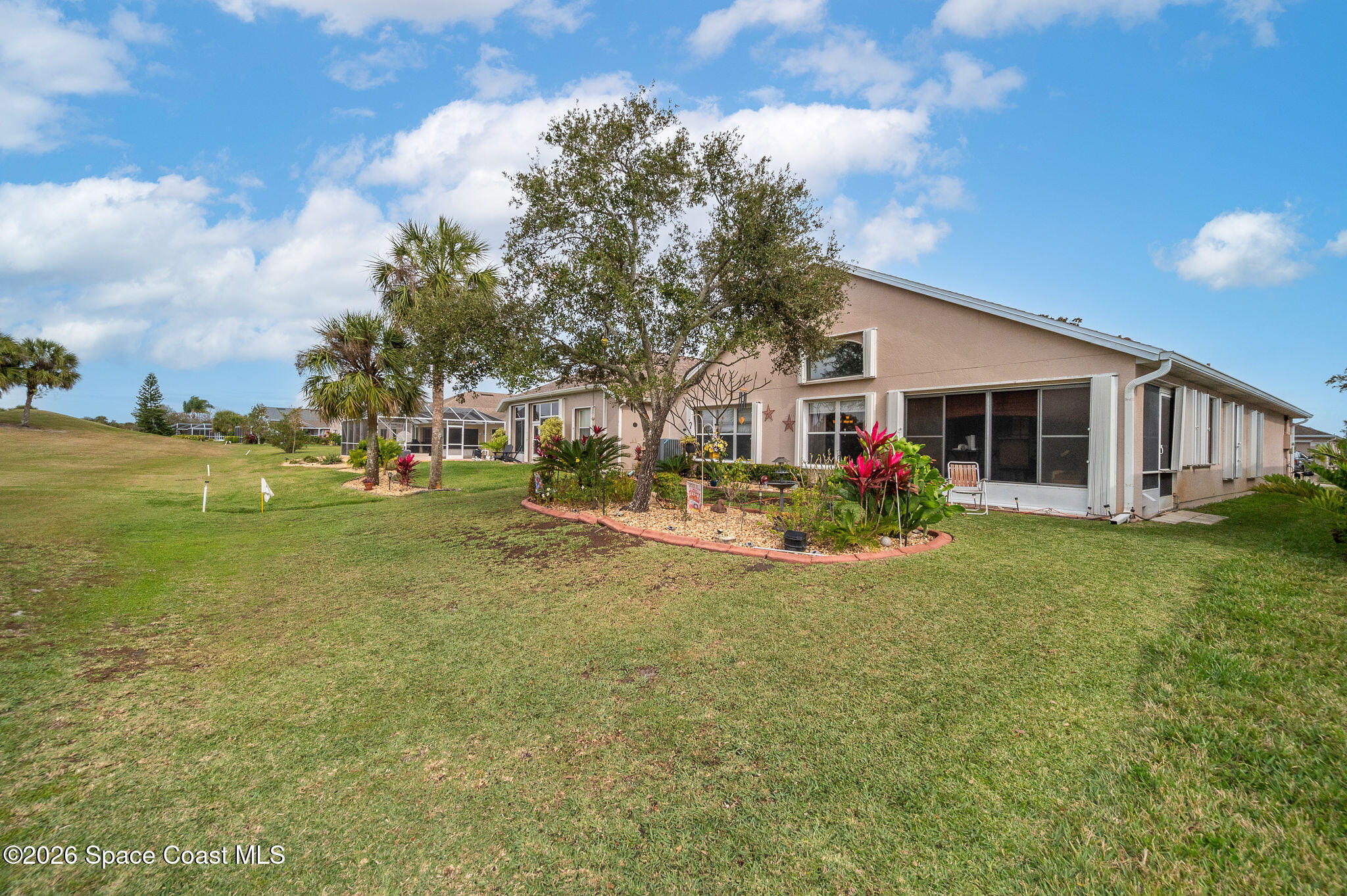 4910 Worthington Circle Rockledge, FL 32955 - Photo 46 of 69 a view of a house with a big yard and palm trees