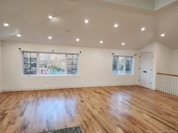 a large kitchen with stainless steel appliances a large counter top a stove and a refrigerator