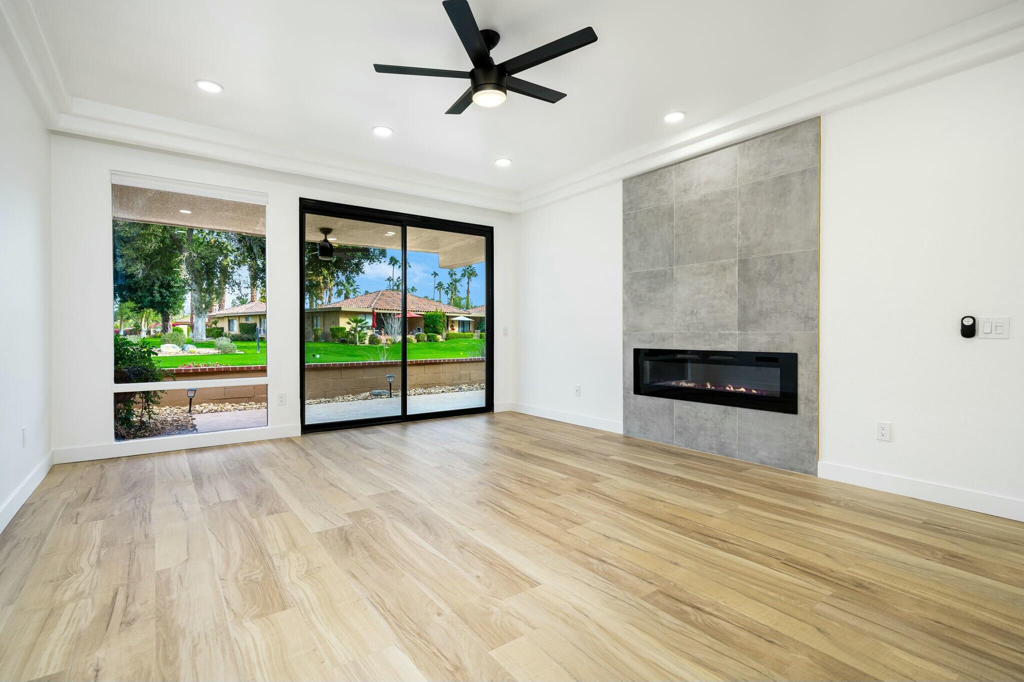 75 Sunrise Drive Rancho Mirage, CA 92270 - Photo 13 of 40 a view of an empty room with a fireplace and a window