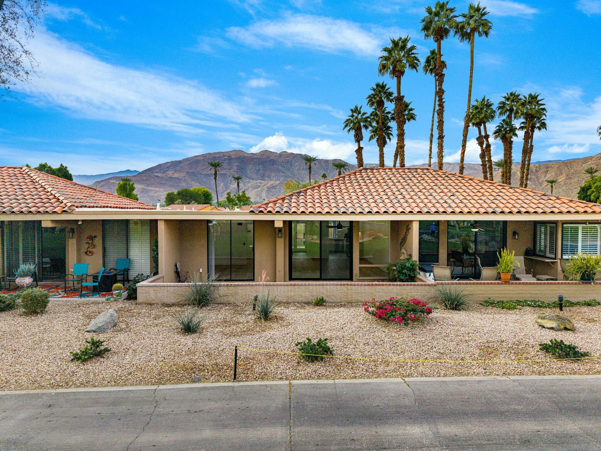 75 Sunrise Drive Rancho Mirage, CA 92270 - Photo 32 of 40 a backyard of a house with barbeque oven table and chairs