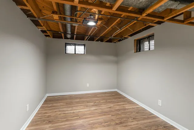 a view of a room with wooden floor
