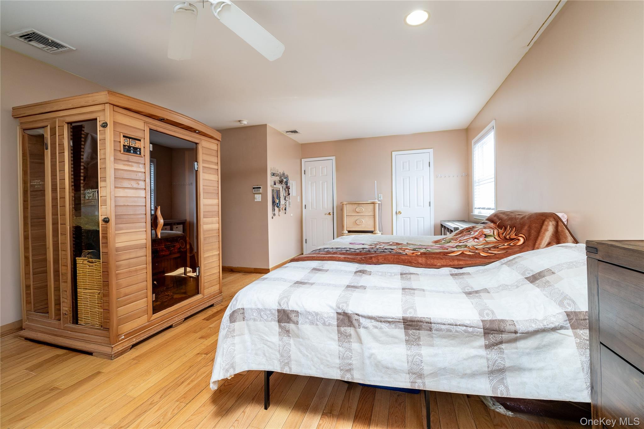 458 East Pine Street Long Beach, NY 11561 - Photo 18 of 26 a bedroom with a bed and a mirror