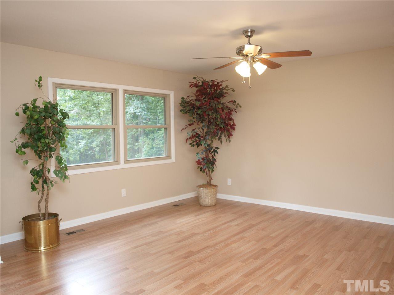 7505 Ray Road Raleigh, NC 27613 - Photo 8 of 18 a view of wooden floor and a window in a room