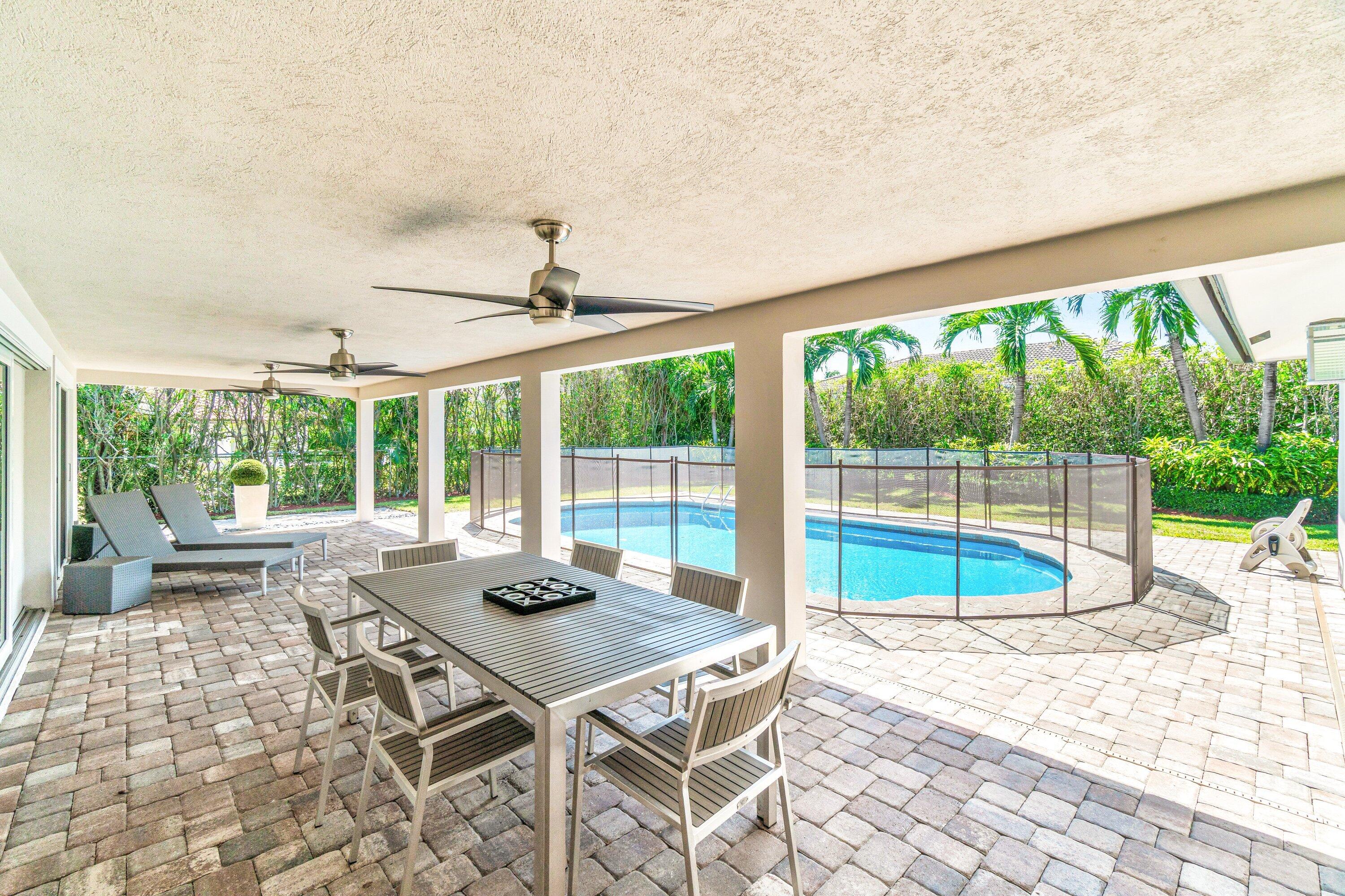 2367 Queen Palm Road Boca Raton, FL 33432 - Photo 38 of 44 a view of a dining room with furniture large windows and wooden floor