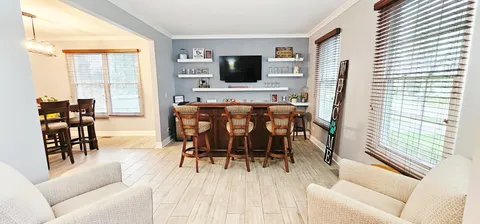 a kitchen with a refrigerator and a stove top oven