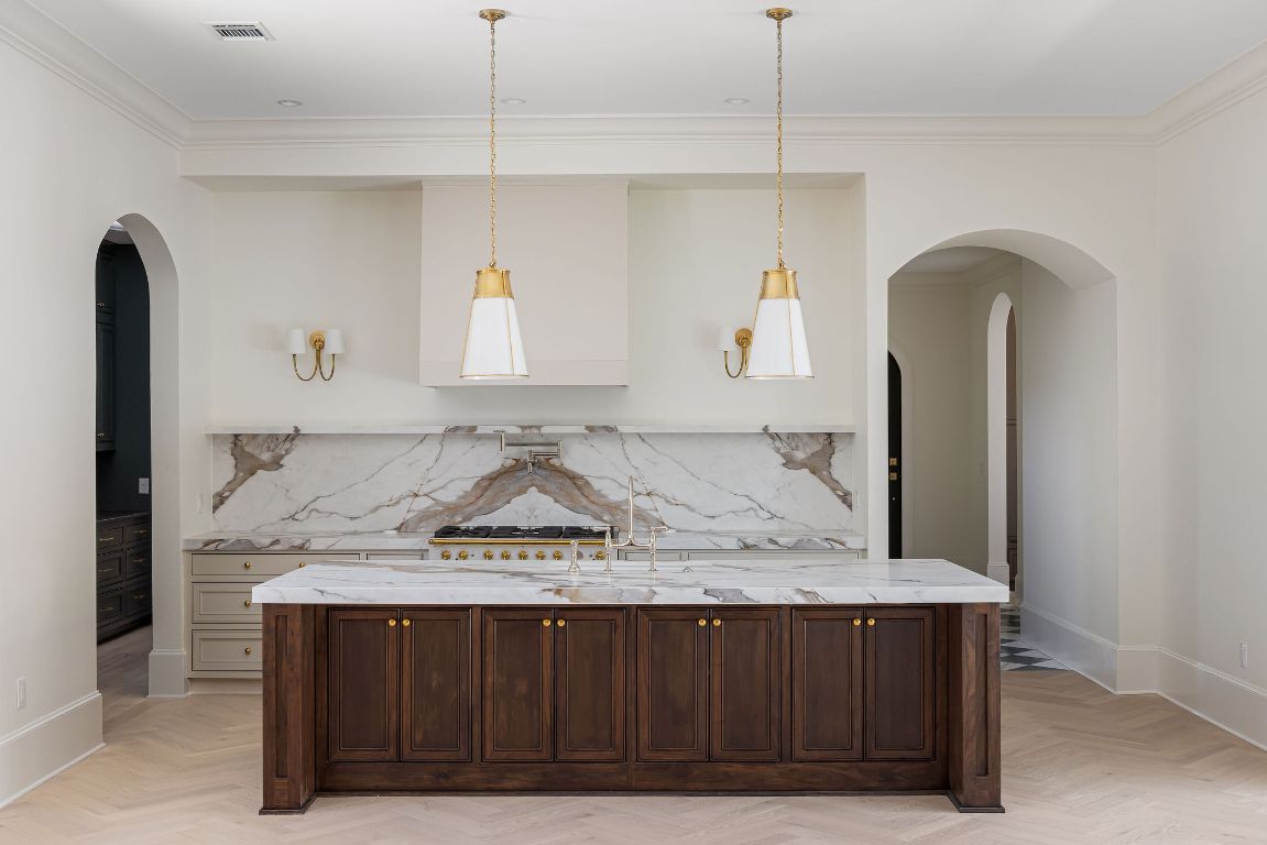 Brass Robinson pendant lighting over your large island with Perrin and Rowe Georgian Era polished nickel kitchen faucet. Such a statement!