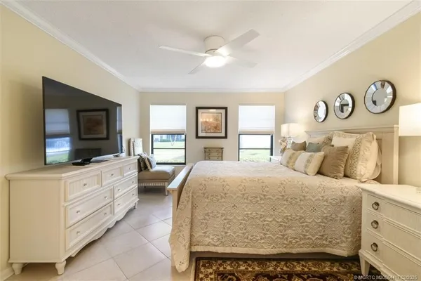 a large bedroom with a bed and a flat screen tv