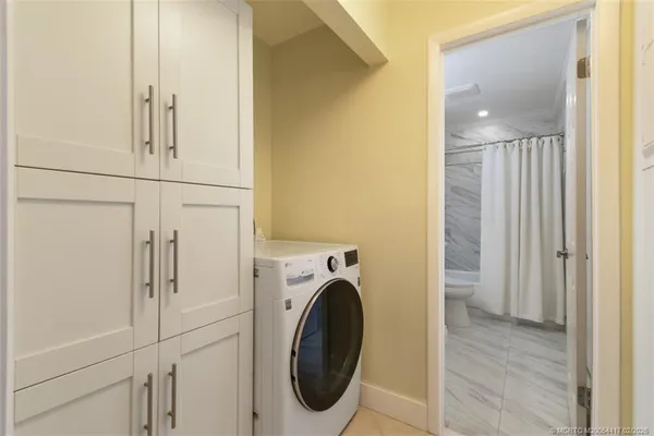 a view of a bathroom with washer and dryer