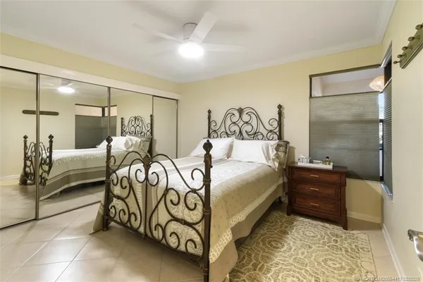 a bedroom with a bed and a mirror