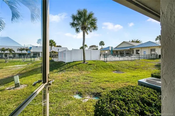 a view of a swimming pool with a patio and a yard