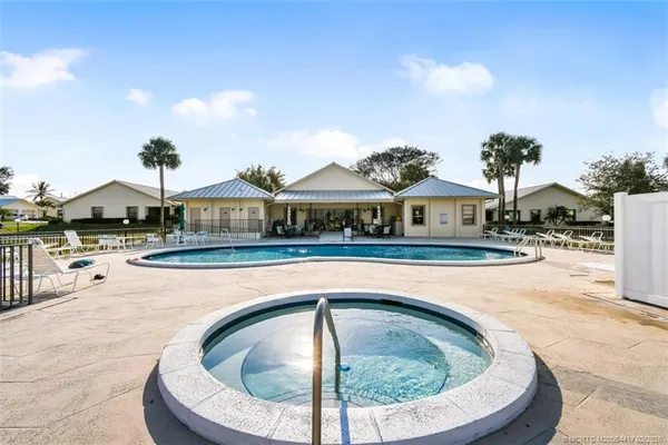 a swimming pool with outdoor seating yard and barbeque oven