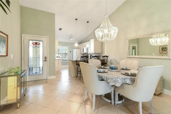 a view of a dining room with furniture and a chandelier