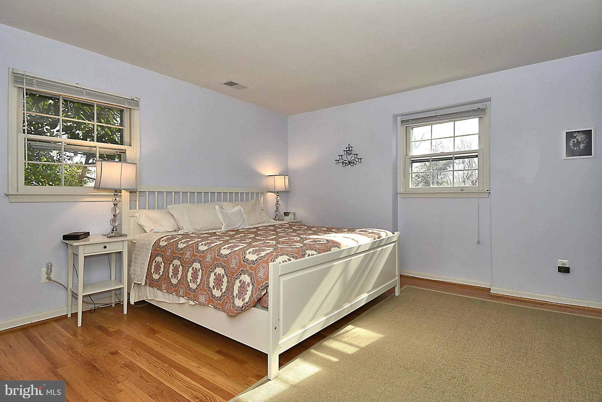 1712 Billman Lane Silver Spring, MD 20902 - Photo 14 of 30 a bedroom with a bed and windows