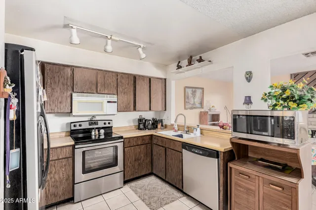a kitchen with a sink stove and microwave