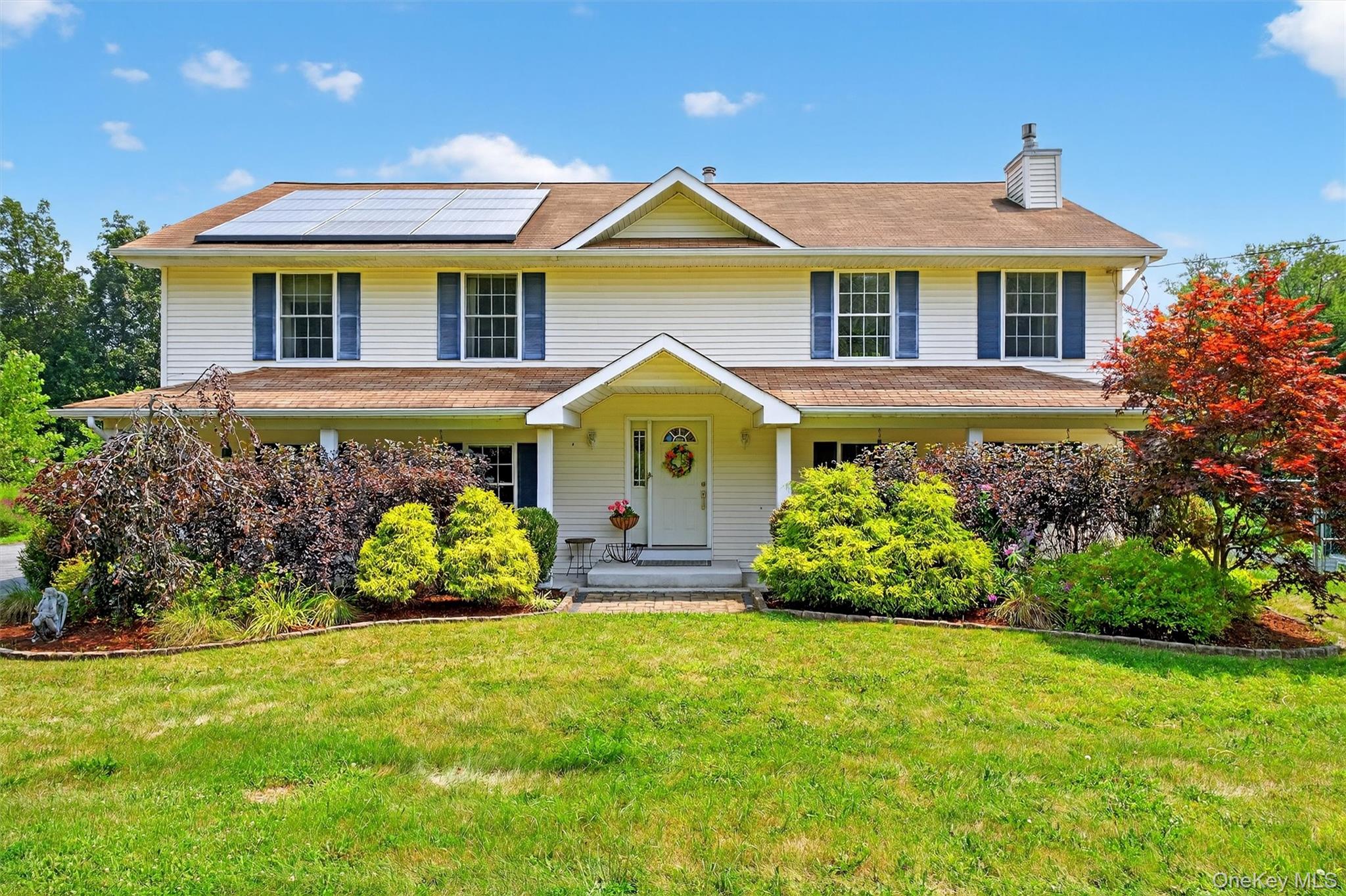 a front view of a house with a garden