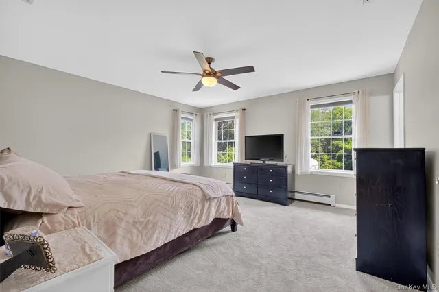 a spacious bedroom with a bed and a couch