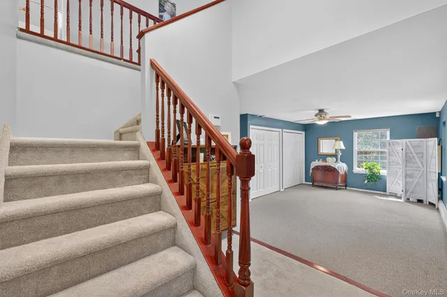 a view of a couches with wooden floor and stairs