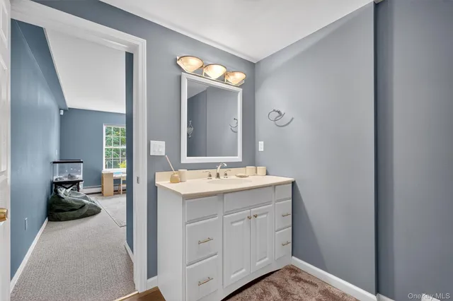 a view of bathroom with a sink and mirror