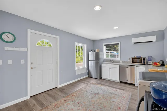 a view of a kitchen with a sink dishwasher and wooden floor