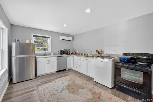 a kitchen with white cabinets and white appliances