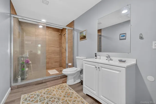 a bathroom with a sink toilet and shower