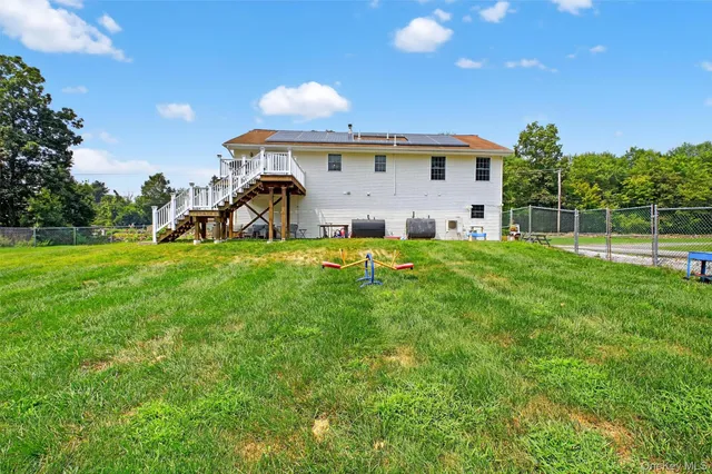 a backyard of a house with table and chairs