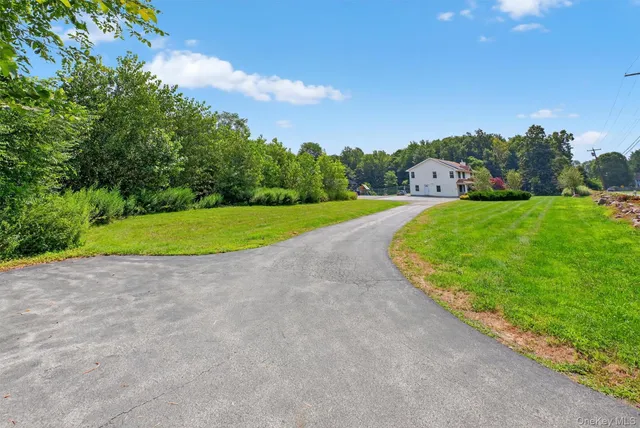 a view of a big yard with large trees