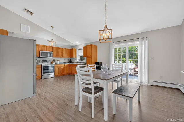 a view of a dining room with furniture window and wooden floor