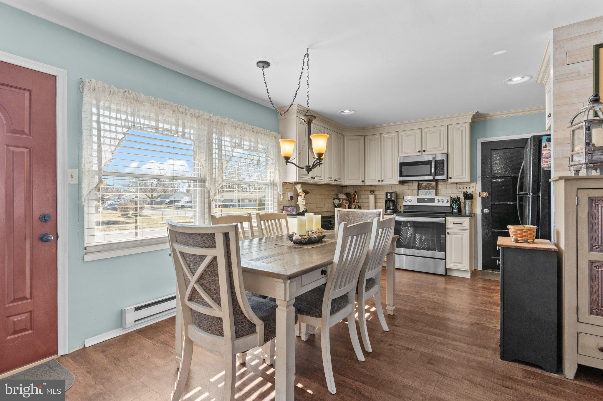 56 Old Pond Road Levittown, PA 19057 - Photo 4 of 20 a view of a dining room with furniture large window and wooden floor