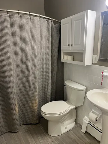 a close view of a toilet and a shower curtain