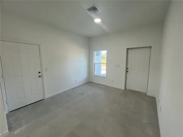 a view of an empty room with a window