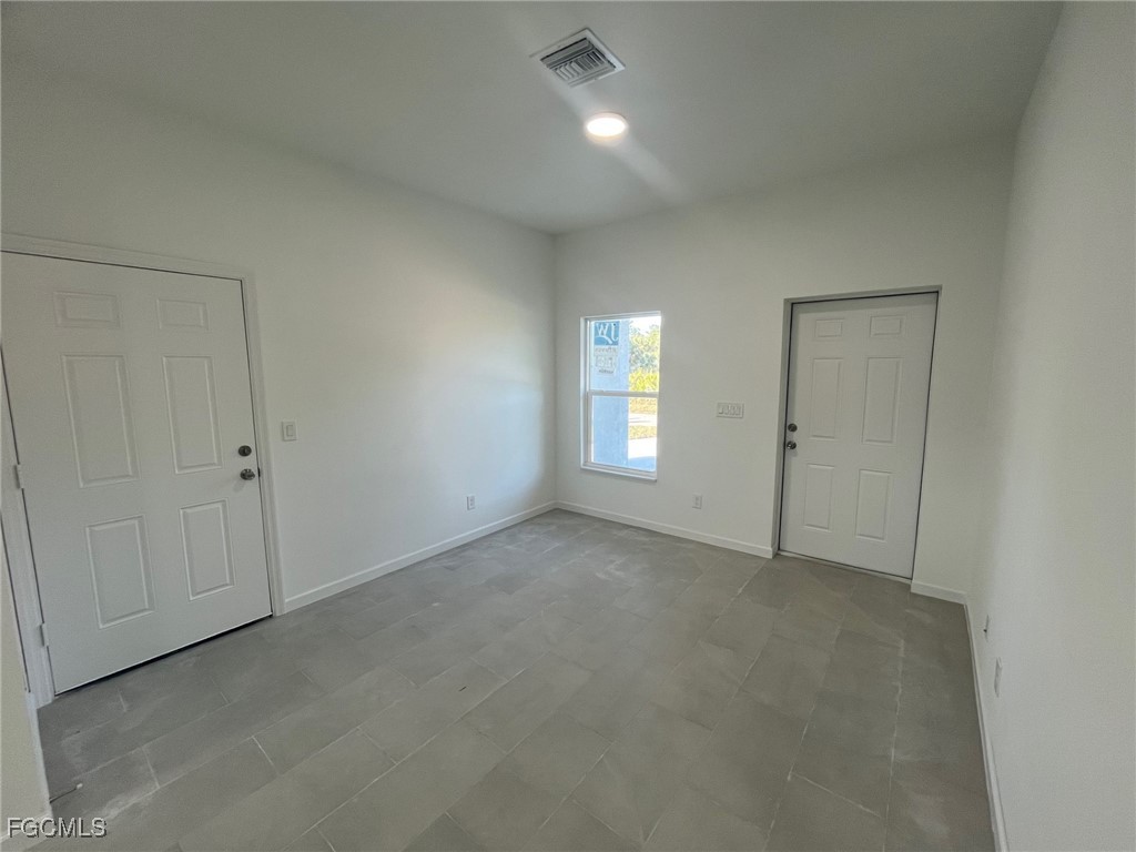 3307 50th Street West Lehigh Acres, FL 33971 - Photo 2 of 15 a view of an empty room with a window