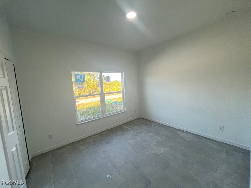 3307 50th Street West Lehigh Acres, FL 33971 - Photo 6 of 15 an empty room with a window
