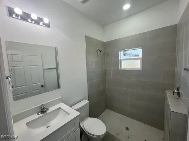 an empty room with a window and a bathroom