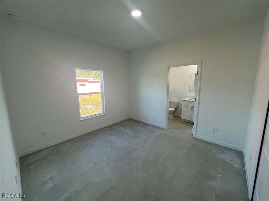 3307 50th Street West Lehigh Acres, FL 33971 - Photo 9 of 15 an empty room with a window and a bathroom