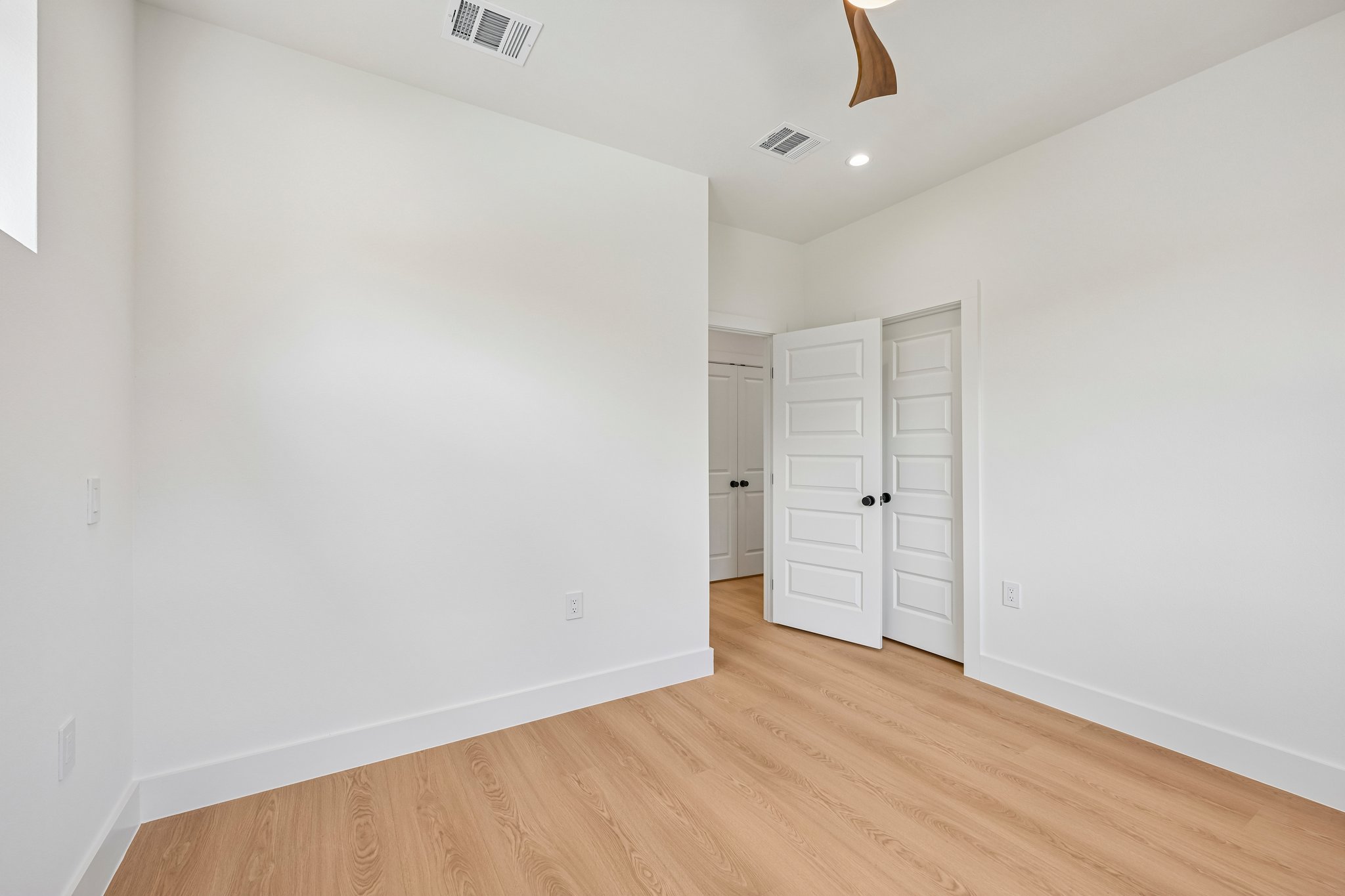 513 West Odell Street, Unit B Austin, TX 78752 - Photo 32 of 38 Blonde wood look flooring and bright white walls create a clean, modern aesthetic.
