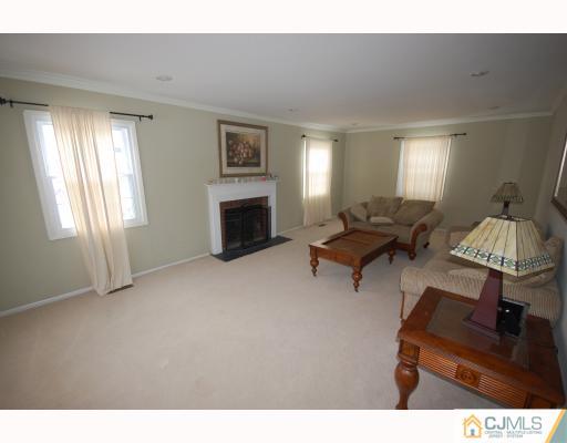 4 Edgewood Road Old Bridge, NJ 07747 - Photo 3 of 7 a living room with furniture and a fireplace