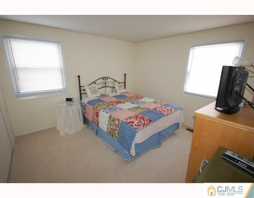 4 Edgewood Road Old Bridge, NJ 07747 - Photo 5 of 7 a bedroom with a bed and window
