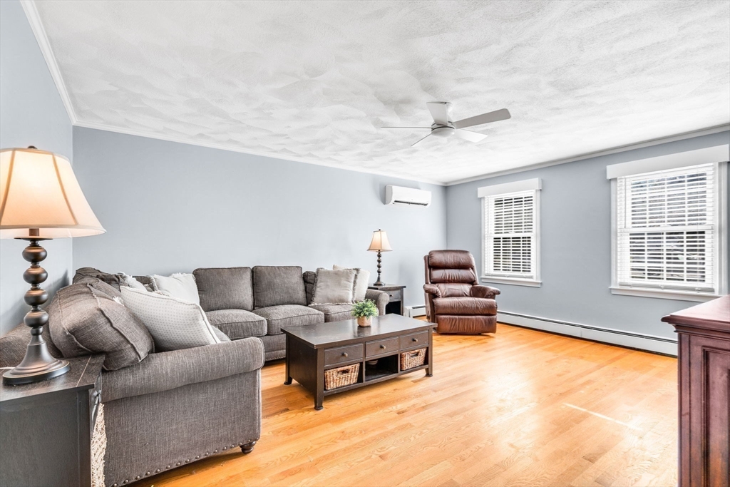 3 Erin Lane Norfolk, MA 02056 - Photo 12 of 37 a living room with furniture and a window