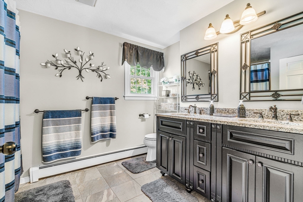 3 Erin Lane Norfolk, MA 02056 - Photo 25 of 37 a spacious bathroom with a granite countertop sink a mirror and a shower