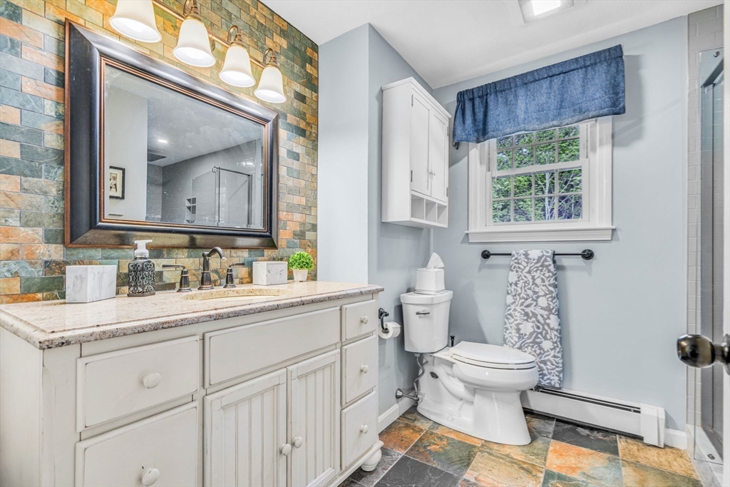 3 Erin Lane Norfolk, MA 02056 - Photo 28 of 37 a bathroom with a sink a toilet and a window