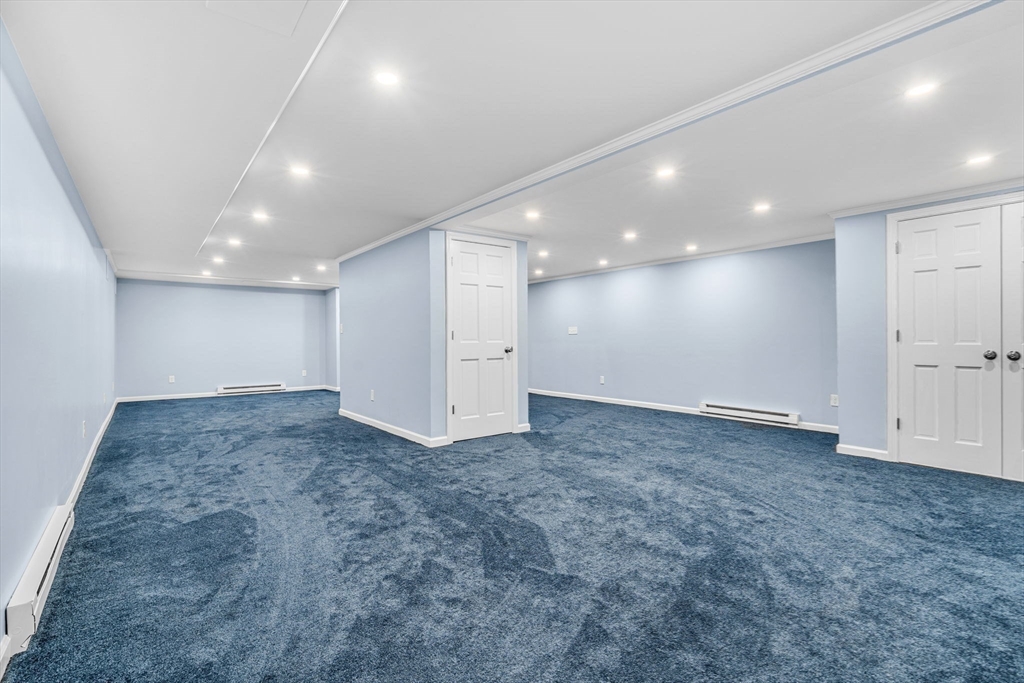 3 Erin Lane Norfolk, MA 02056 - Photo 32 of 37 an empty room with a ceiling fan