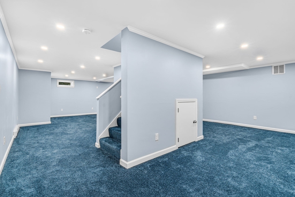 3 Erin Lane Norfolk, MA 02056 - Photo 33 of 37 an empty room with windows and pillars