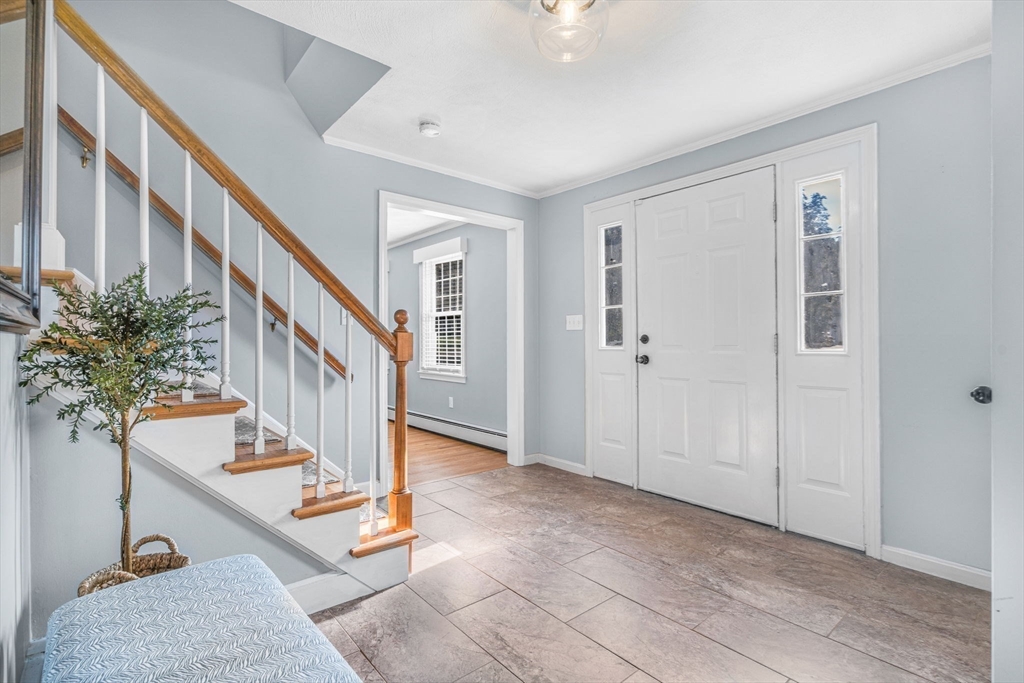 3 Erin Lane Norfolk, MA 02056 - Photo 4 of 37 a view of staircase with white walls and a potted plant