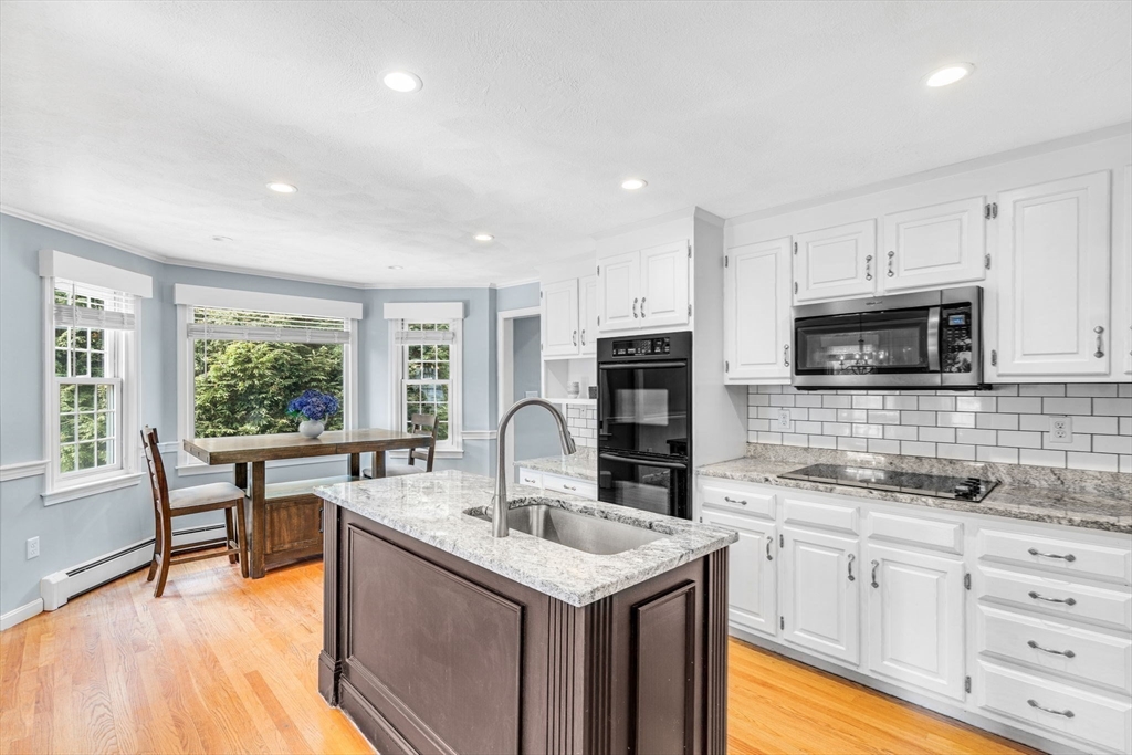 3 Erin Lane Norfolk, MA 02056 - Photo 9 of 37 a kitchen with stainless steel appliances granite countertop a sink stove and cabinets