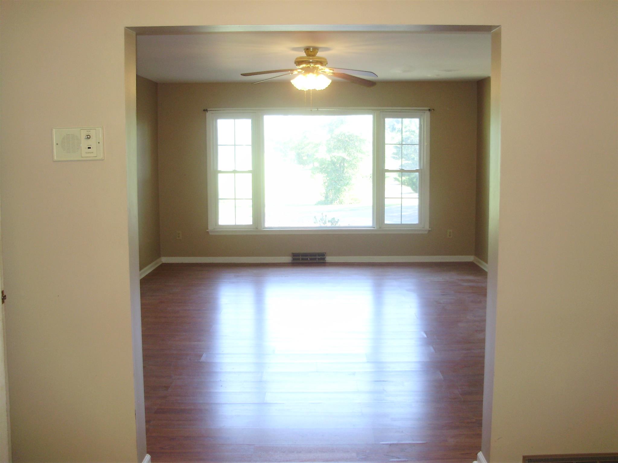 51 Ramah Road Leoma, TN 38468 - Photo 12 of 30 an empty room with wooden floor and windows