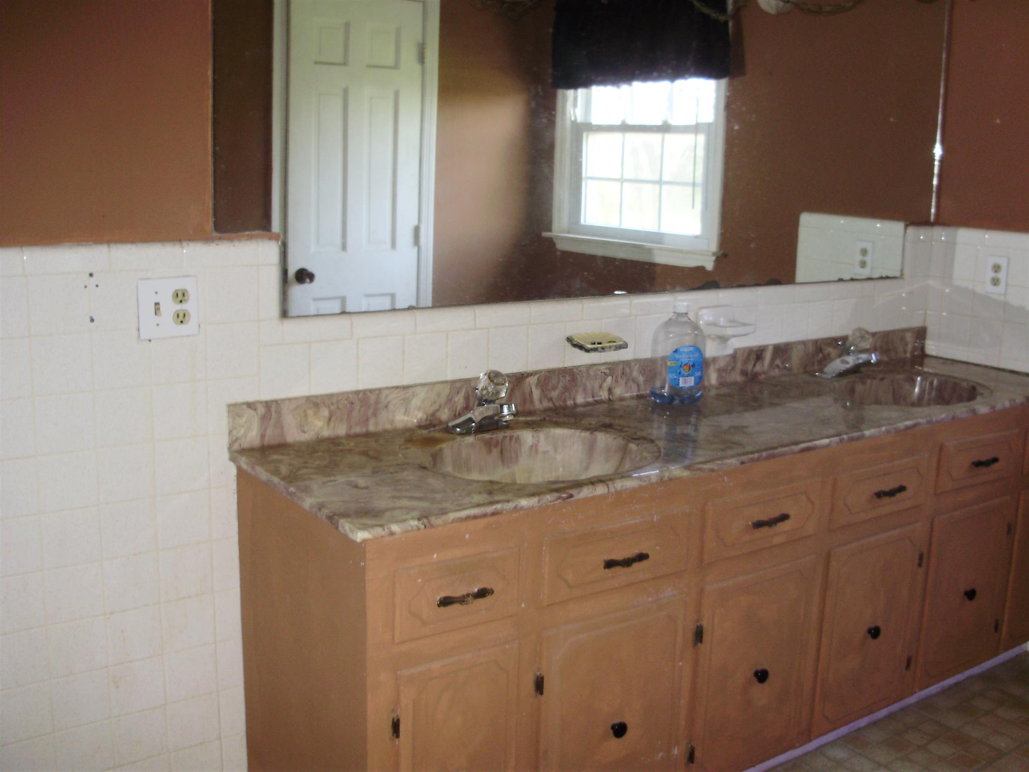 51 Ramah Road Leoma, TN 38468 - Photo 26 of 30 a bathroom with a granite countertop sink a mirror and a window