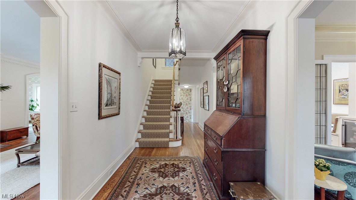 2854 East Overlook Road Cleveland, OH 44118 - Photo 11 of 35 Entryway featuring ornamental molding, a notable chandelier, and light hardwood / wood-style flooring