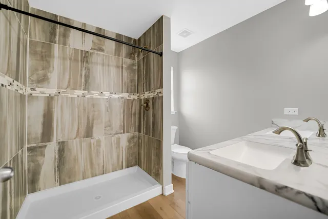 a bathroom with a shower and a sink